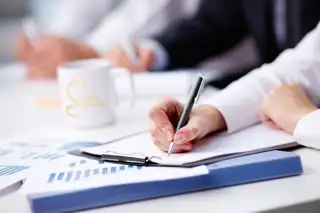Close Up Busy Businesswoman Writing