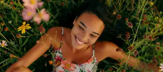 Young Woman Floral Dress Lying Field Wildflowers