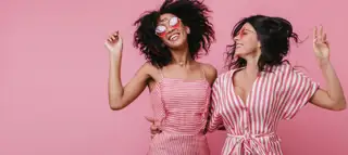 Excited Young Ladies Jumping Laughing Portrait African Girl With Short Hairstyle Dancing With Her Best Friend