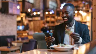 Man Holding Gold Mvg Card In Restaurant